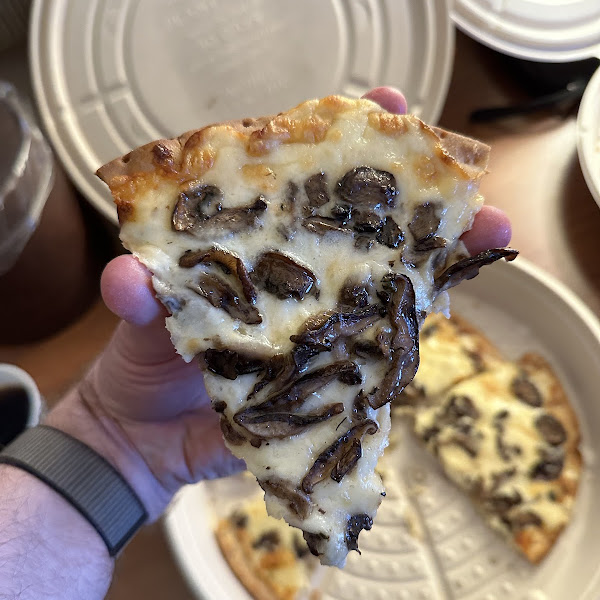 Wild Mushroom pizza on a gluten-free crust served in a compostable to-go box