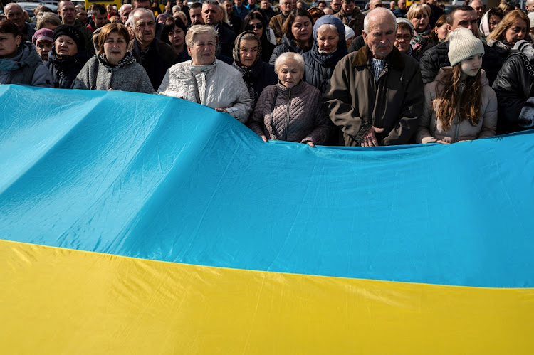 Mourners attend the funeral ceremony of Ukrainian serviceman Roman Tiaka, who was killed during Russia’s invasion of Ukraine, in Stebnyk, Lviv region, Ukraine, on April 12 2022. Picture: REUTERS/VIACHESLAV RATYNSKYI