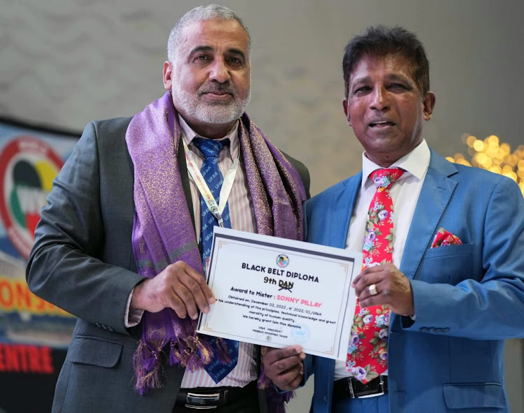 Sonny Pillay, right, receives his award from African Karate Federation (UFAK) president Tahar Misbahi.