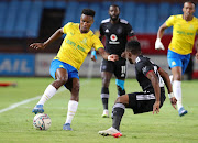 Themba Zwane of Mamelodi Sundowns is challenged by Paseka Mako of Orlando Pirates in the DStv Premiership match at Loftus Versfeld in Pretoria on December 17 2021.