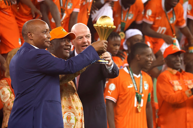 Ivory Coast president Alassane Ouattara celebrates after the match with Confederation of African Football president Patrice Motsepe and Fifa president Gianni Infantino after the Elephants won the Africa Cup of Nations final against Nigeria at Stade Olympique Alassane Ouattara in Abidjan, Ivory Coast on Sunday.