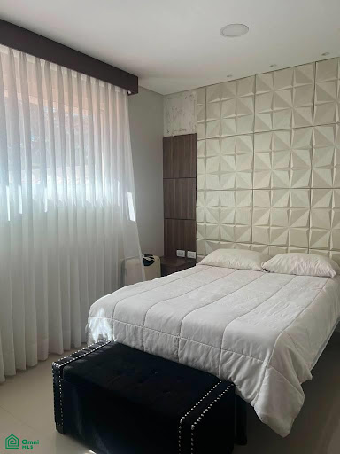 Bedroom with double bed, textured headboard in this luxury house for sale in Santa Cruz de la Sierra ($1,300,000 - 900 m²)