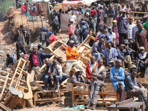 Anxious traders look at the aftermath of the fire that razed Gikomba market on June 28/ KENNEDY NJERU