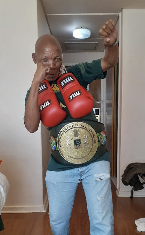 Veteran trainer Bushy Mabele poses with the SA middleweight belt his boxer John Bopape won on Friday last week.