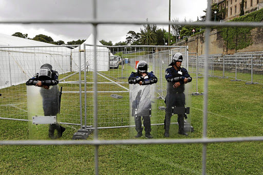 TESTING TIMES: Guards wait outside the giant tent on UCT's sports fields where students will be writing final exams.