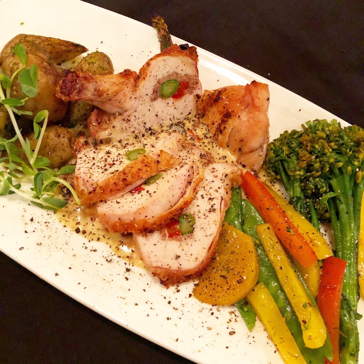 Tuscan Chicken Supreme - a wing-on breast stuffed with Prosciutto, Asparagus, Roasted Peppers and Goat Cheese.  Topped with a Sun-dried tomato and Bacon Cream sauce!