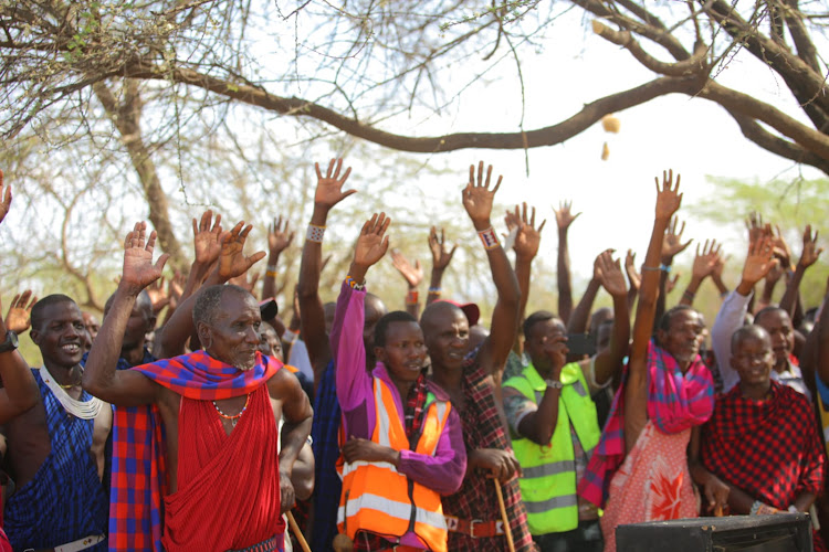 Residents and employees applaud Governor Joseph Ole Lenku