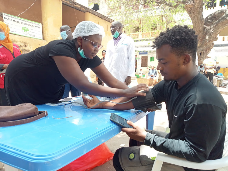 Lamu nurse Connie Zighani takes the blood pressure vitals of Abdilali Shee during a blood donation drive at Mkunguni square in Lamu island.