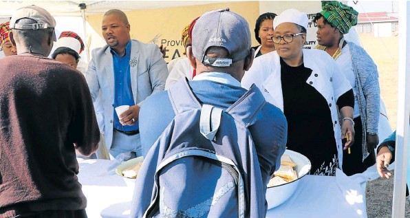 Social development MEC Dr Pumza Dyantyi and ward 27 councillor Boy Boy Kalani feed hundreds of hungry people in Mzamomhle on Tuesday. About 100 people are fed daily at the centre.