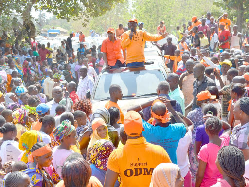 hapa ni chungwa tu: Cord leader Raila Odinga presents the ODM flag bearer for the Malindi MP byelection Willy Mtengo to the electorate at Ganda, Kilifi county, on February 8.