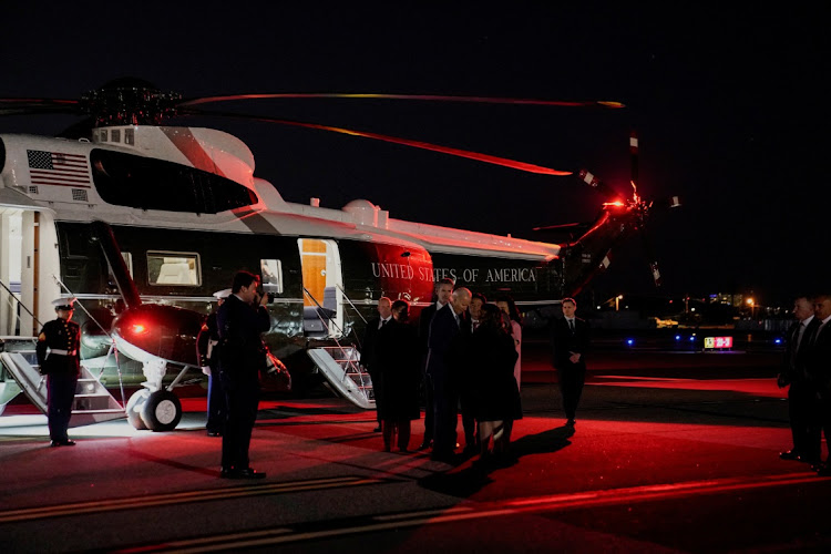 US President Joe Biden is greeted by officials after he disembarked from Marine One, at Santa Monica Airport in Santa Monica, California, US, December 8, 2023.