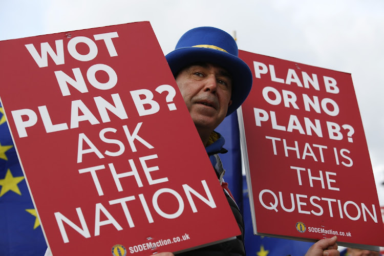 Steve Bray, an anti-Brexit demonstrator, holds placards during ongoing pro and anti Brexit protests outside the Houses of Parliament in London, U.K., on January 22 2019. Picture: BLOOMBERG/ LUKE MACGREGOR