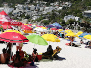 Hundreds of beachgoers strolled carefree along Clifton's Fourth Beach despite earlier scenes characterised by protests