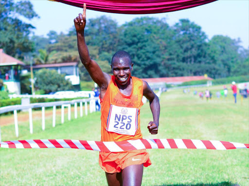 Geoffrey Kamoworor celebrates after winning the National Police Service cross country championships at Ngong race course / ERICK BARASA