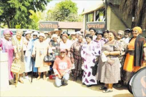 expedition: The Sisonke Senior Citizens Club took a break from charity work to play tourists at Orlando East's famous Vilakazi Street as part of their festive season celebrations.