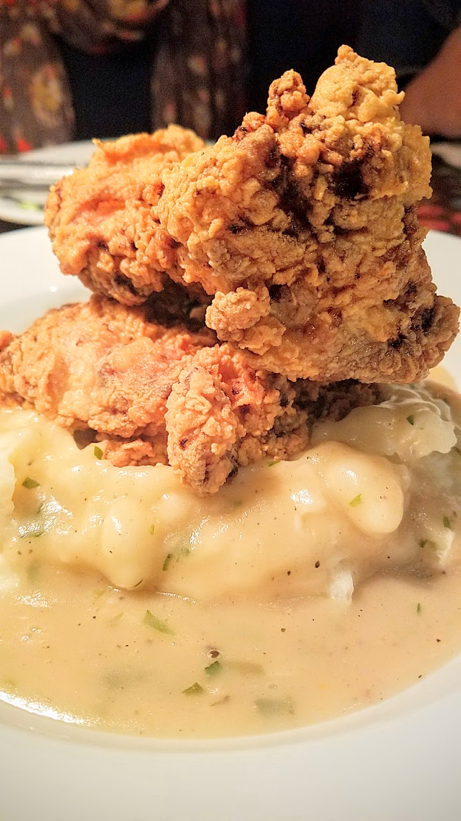 Example Food at Saraveza buttermilk fried chicken with mashed potatoes and braised chard and tarragon gravy