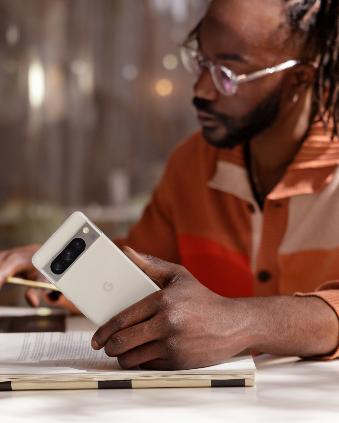 A man using a Google Pixel 8 phone to work.