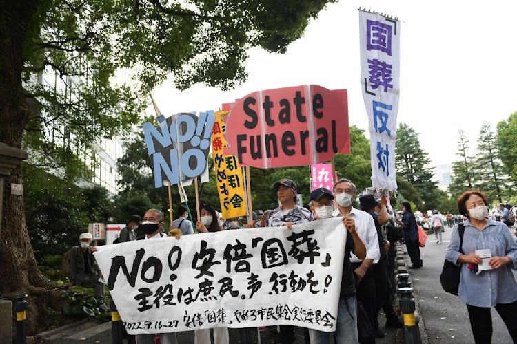 Demonstrators hold placards during a protest against the planned state funeral for slain former Prime Minister Shinzo Abe in Tokyo, Japan on September 17 2022. Picture: Noriko Hayashi/Bloomberg