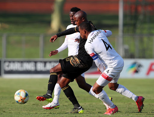 Levy Mashiane of Royal AM challenged by Riaan Hanamub and Maloisane Mokhele of Chippa United during the DStv Premiership match between Royal AM and Chippa United at Chatsworth Stadium on September 12, 2021 in Durban, South Africa.