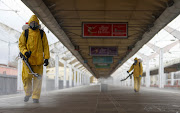 Specialists wearing personal protective equipment (PPE) spray disinfectant while sanitizing the Leningradsky railway station amid the outbreak of the coronavirus disease (Covid-19) in Moscow, Russia October 19, 2021. 