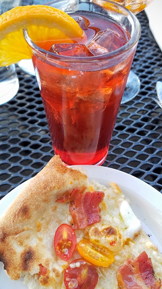 Ken's Artisan Pizza, 12 inch thin crust perfection, this one is the Cherry Tomato Pancetta Bomb with chopped garlic, mozzarella di bufula, and pecorino romano along with the cocktail Negorni Sbagliato with Meletti 1870 bitter, Cinzano Sweet, Sparkling Wine, orange wheel