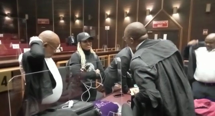 Jacob Zuma's daughter Duduzile Zuma-Sambudla talks to her father's legal team including advocate Dali Mpofu in the Pietermaritzburg high court on Monday.
