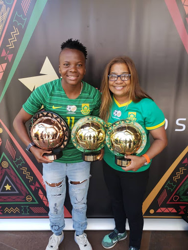 Striker Thembi Kgatlana (L) and coach Desiree Ellis (R) pose with their Caf Awards.