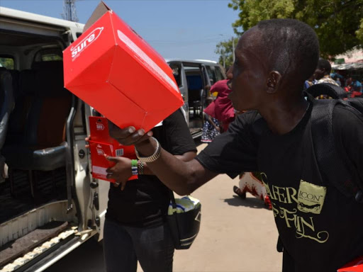 Condoms being distributed to Kilifi boda boda riders and matatu touts during the International Condom Day celebratiosn outside Pwani University on Wednesday February 13, 2019. /ALPHONCE GARI