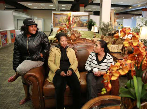 MUCH-NEEDED BREAK: Exhibitors Susan Mphanza, Betty Mwale and Brigette Arries take a break from setting up their stands at the Your Home Expo which runs from today until Sunday at the ICC Picture: ALAN EASON