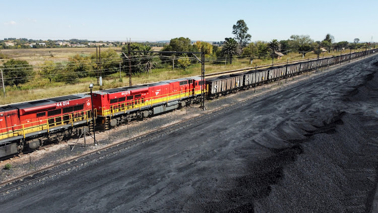 A Transnet freight rail train is seen next to tons of coal mined from the nearby Khanye Colliery mine, at the Bronkhorstspruit station, in Bronkhorstspruit. File picture.