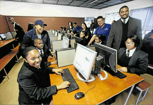 POSITIVE IMPACT: Khulani Commercial High School principal Vuyisile Badiyana with pupils using computers donated from pupils last week. Picture: SINO MAJANGAZA