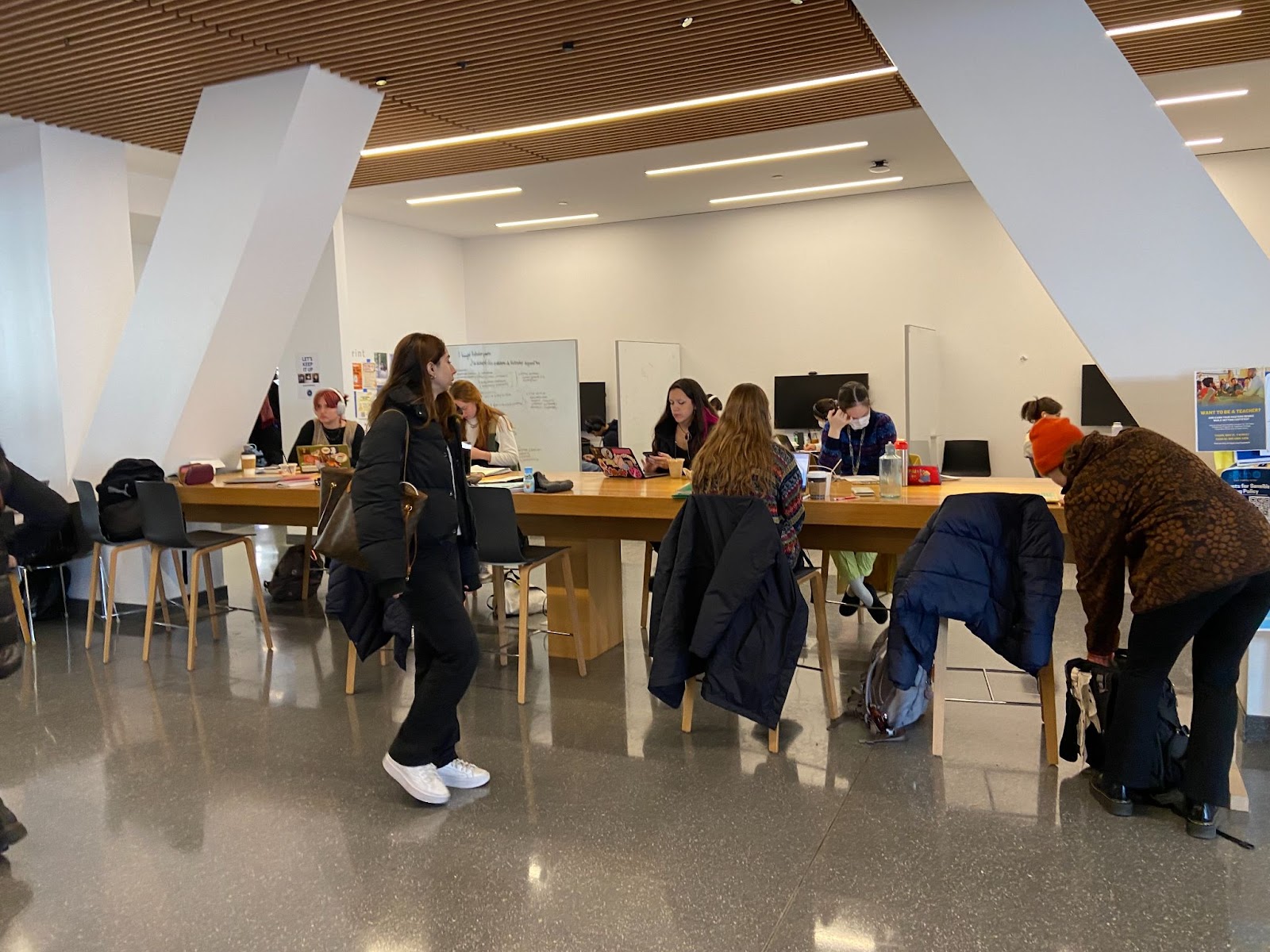 students sitting at table on computers