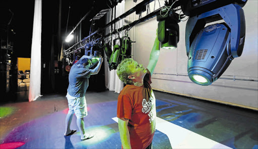 BRIGHTER PROSPECTS: Zane Flanagan, front, and Andre Donaldson of East London’s Guild Theatre show off the new LED stage lights bought with funds given by the National Lotteries this year Picture: ALAN EASON