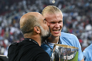 Manchester City manager Pep Guardiola kisses Erling Haaland after the team's victory in the Uefa Super Cup 2023 match against Sevilla FC at Karaiskakis Stadium in Piraeus, Greece on August 16 2023.