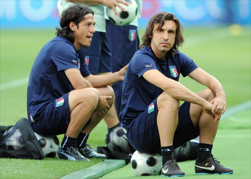 A file photo of Italian midfielders Mauro Camoranesi (L) and Andrea Pirlo (R) resting during a training session in Austria.