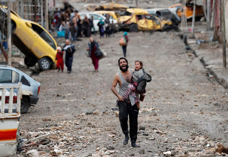 A man cries as he carries his daughter while walking from an Islamic State-controlled part of Mosul towards Iraqi special forces soldiers during a battle in Mosul, Iraq March 4, 2017.