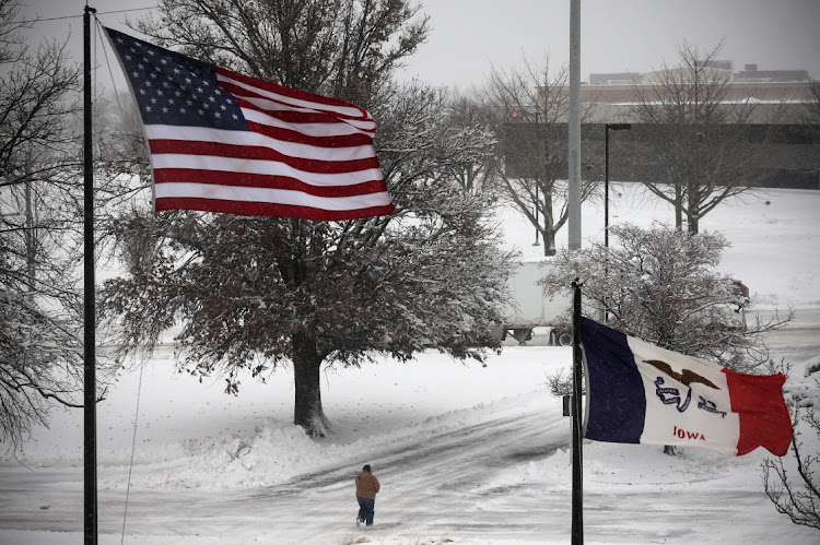 A person walks in snow and high winds as a winter storm moves through the midwest United States in Des Moines, Iowa, U.S., January 9, 2024. Picture: MIKE SEGAR