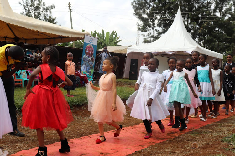 Pupils catwalk to entertain guests during the Kerugoya Municipality Primary School open day and talent academy launch.