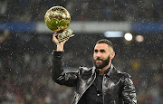 France striker Karim Benzema displays the Fifa Ballon d'Or award before the La Liga match between his club, Real Madrid, and Sevilla at Estadio Santiago Bernabeu in Madrid on October 22 2022.