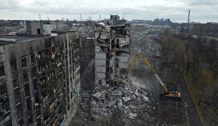 An excavator demolishes a multi-storey apartment block, which was destroyed in the course of Russia-Ukraine conflict in Mariupol, Russian-controlled Ukraine, February 15, 2023.