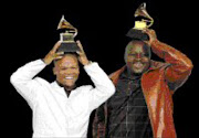 WINNERS: Lucas Bok and Shimmy Jiyane with the Grammy Award. Pic. Lucy Nicholson. 10/02/08. © Reuters.