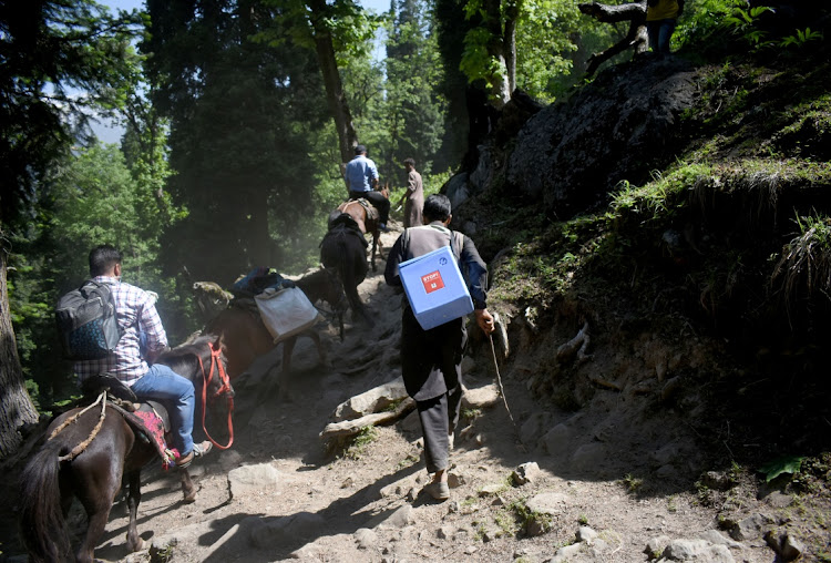 Healthcare workers and porters trek to inoculate shepherds with COVISHIELD, a coronavirus disease (COVID-19) vaccine manufactured by Serum Institute of India, during a vaccination drive at Lidderwat near scenic Pahalgam in south Kashmir's Anantnag district, June 10, 2021. Picture taken June 10, 2021.