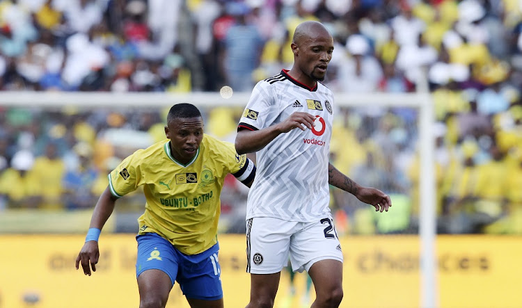 Andile Jali of Mamelodi Sundowns shadows Goodman Mosele of Orlando Pirates in the MTN8 semifinal first leg match at Orlando Stadium on October 1 2022.