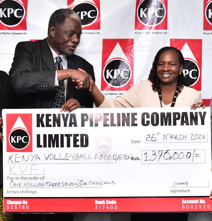 KPC's Human Resource and Administration General Manager hands over a dummy cheque to Kenya Volleyball Federation (KVF) President Charles Nyaberi.