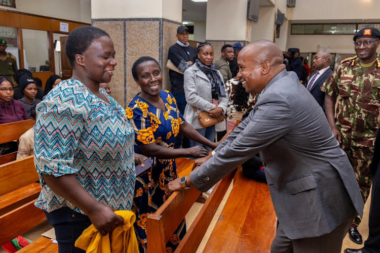 Interior CS Kithure Kindiki interacts with Kenyan who had come to seek services at Nyayo House on May 6, 2024.