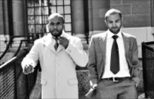 IN THE DOCK: Christopher Billings, left, and a family friend outside the Johannesburg high court yesterday. Billings is one of the accused in the OR Tambo International Airport robbery case in which about R100 million was stolen. Pic. Vathiswa Ruselo. 01/09/2008. © Sowetan.