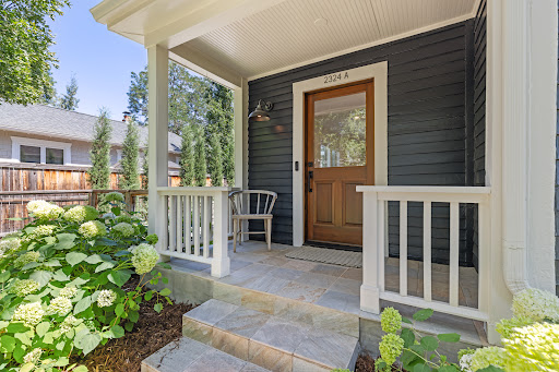 Front porch with wooden door and flowers - Buy this luxury apartment / penthouse in Boulder, 2 bedrooms