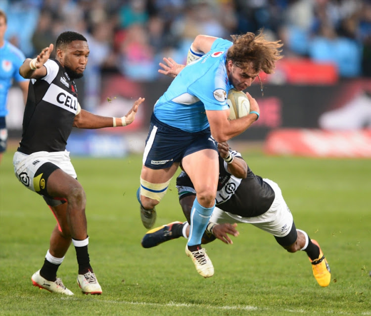 Burger Odendaal (R) of the Bulls gets past Odwa Ndungane of the Sharks during the Currie Cup match between Vodacom Blue Bulls and Cell C Sharks at Loftus Versfeld on August 09, 2017 in Pretoria, South Africa.