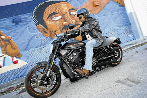 A Harley V-Rod against the backdrop of Miami's street art