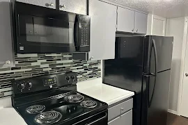 Kitchen with black appliances and backsplash